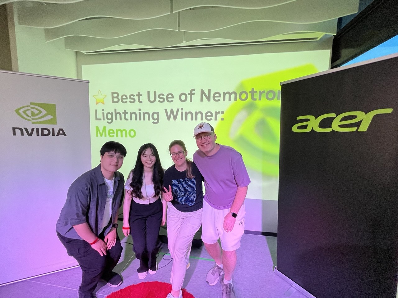 The MEMO team on stage with the NVIDIA and Acer banners, next to a screen reading "Best Use of Nemotron Lightning Winner: Memo"